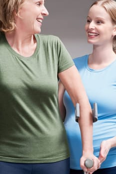 Physiotherapist assisting a patient in walking with crutches