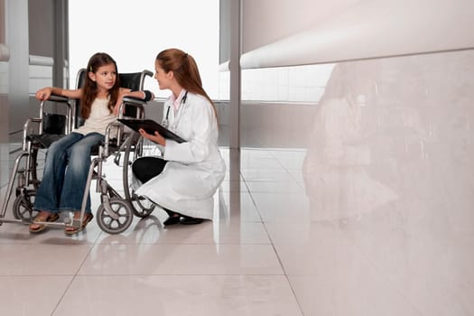 Female doctor with a patient in a wheelchair