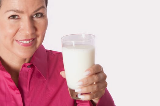 Close_up of a woman holding a glass of milk