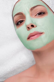 Woman receiving facial treatment