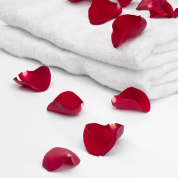Close_up of a stack of towels with rose petals