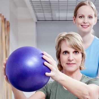 Physiotherapist assisting a patient in exercising
