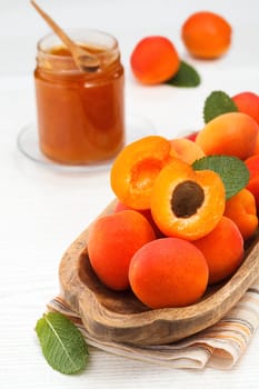Apricots. Ripe fresh apricots on a wooden white background..