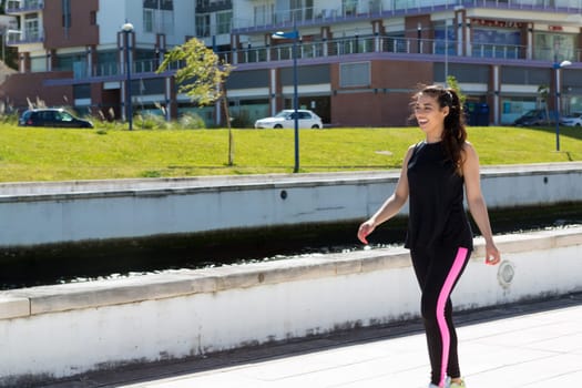 A beautiful young woman making some exercise at the park - fitness concept
