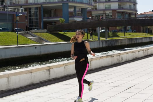 A beautiful young woman making some exercise at the park - fitness concept