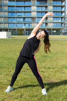 A beautiful young woman making some exercise at the park - fitness concept
