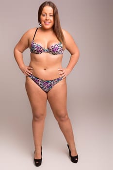 Beautiful large woman posing in lingerie - studio shot