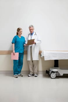 Doctors discussing a medical report with a nurse