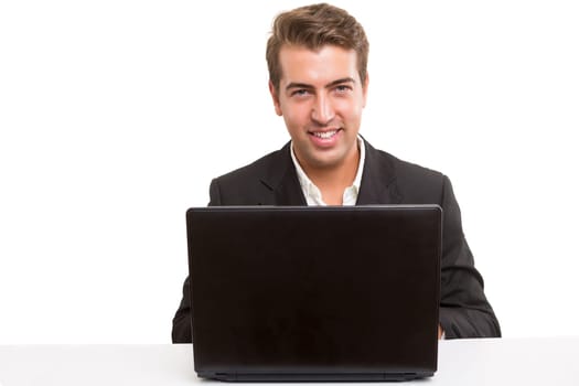 Young handsome man working with laptop computer