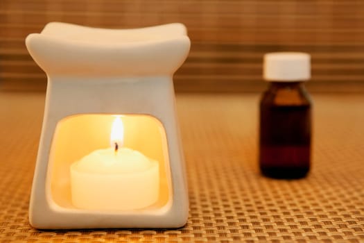 Bottle of aromatherapy oil and a burner
