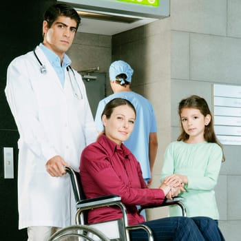 Doctor pushing a woman in a wheelchair
