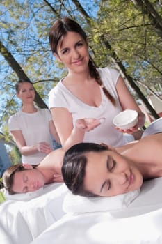 Couple receiving back massage from massage therapists