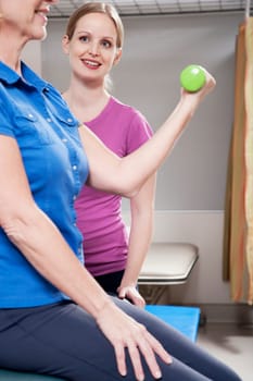 Physiotherapist assisting a patient in exercising