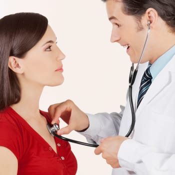 Doctor examining a woman with a stethoscope