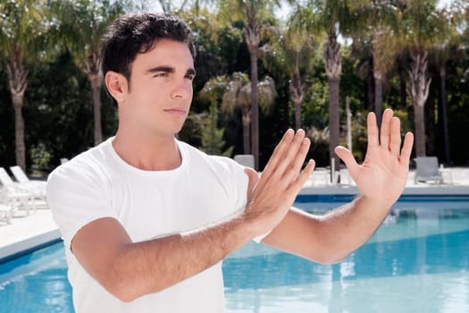 Man exercising at the poolside