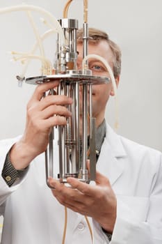 Scientist working on a bioreactor headplate with mixer assembly and methanol sensor probe