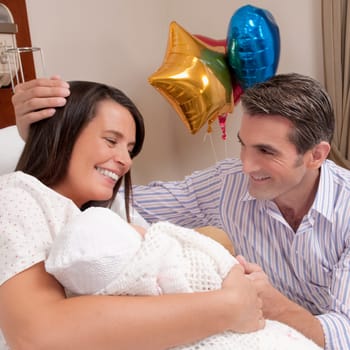 Couple with their newborn baby in a hospital
