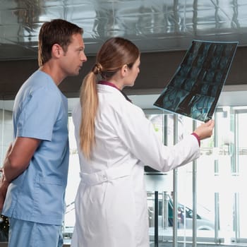 Doctor showing MRI scan to a male nurse