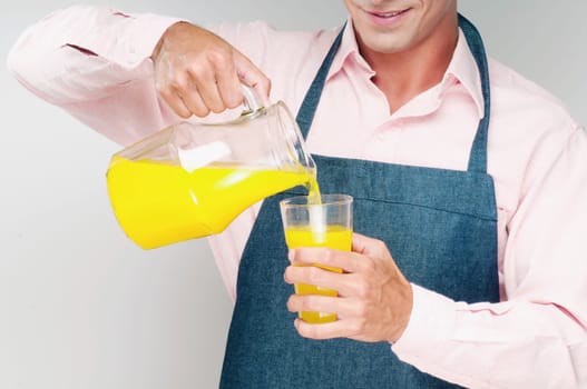 Man pouring orange juice in a glass