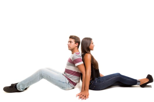 Young couple posing isolated in studio