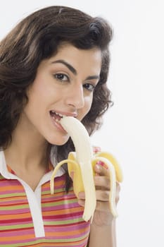 Portrait of a woman eating a banana