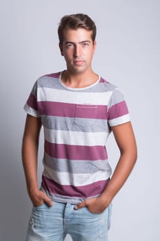 Studio picture of a young and handsome man posing isolated