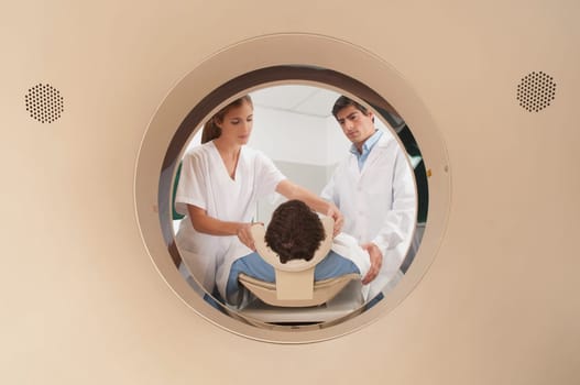 Doctor and nurse preparing a patient for MRI scan