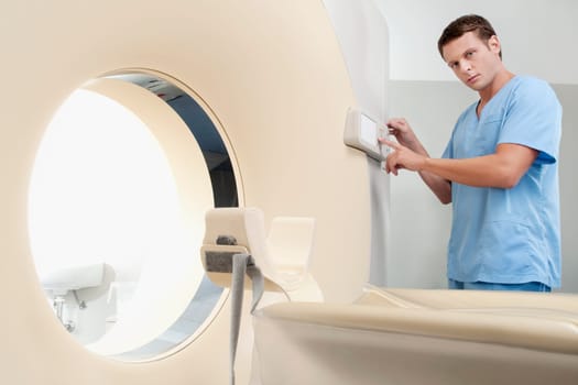 Technician operating an MRI scanner