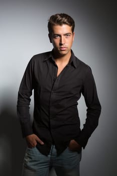 Studio picture of a young and handsome man posing isolated
