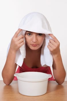 Portrait of a woman inhaling steam