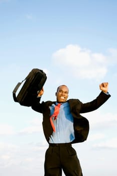 Businessman jumping on the beach