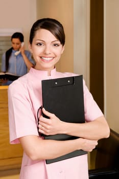 Portrait of a female doctor holding a clipboard and smiling