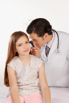 Doctor examining a girlŽs ear with an otoscope
