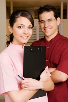 Portrait of a female doctor smiling with a male doctor