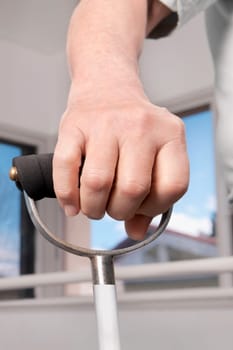 Human hand holding a crutch