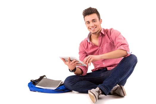 Young happy student working with a new digital tablet computer, isolated