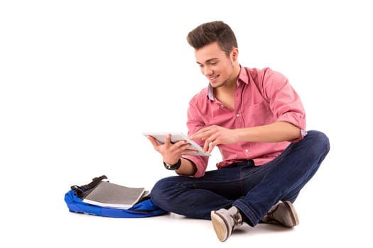 Young happy student working with a new digital tablet computer, isolated