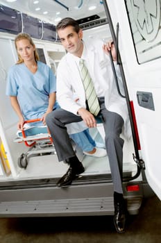 Doctor sitting with a female nurse in an ambulance