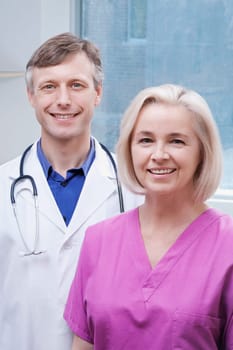 Doctor and a nurse smiling
