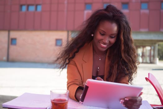 Young african student preparing her exams at a local cafeteria