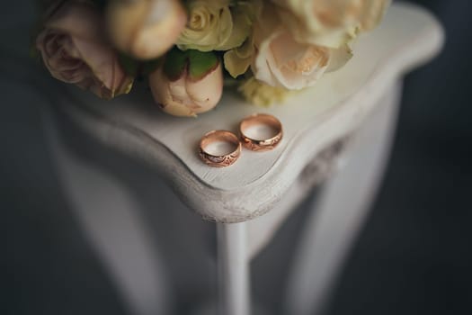 Wedding rings with flowers on the table. High quality photo
