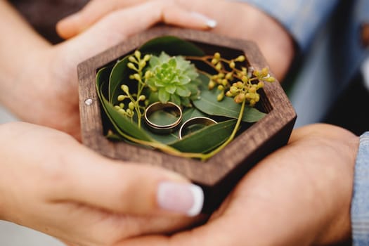 Wedding couple is holding their wedding rings. High quality photo