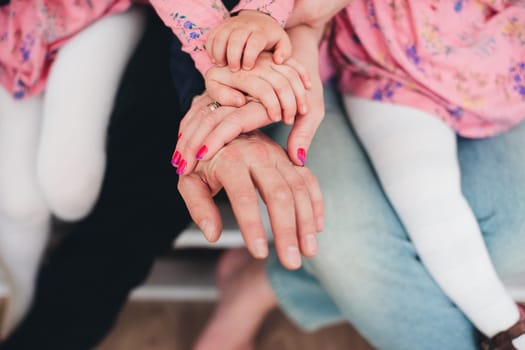 Family hands of four, mother, father and 2 kids. High quality photo
