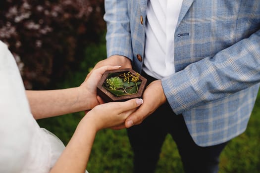 Wedding couple is holding their wedding rings. High quality photo