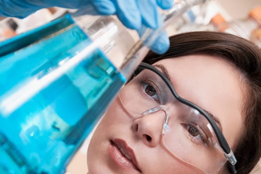 Female doctor holding a conical flask in a laboratory