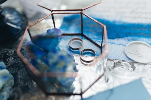 Wedding rings at wedding invitation with decorations. High quality photo