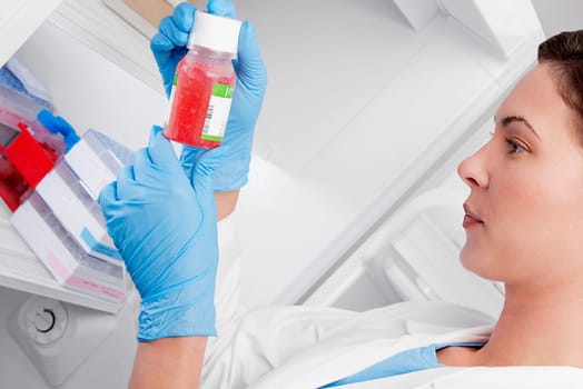 Female doctor holding a bottle of solution in a laboratory