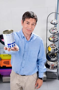 Man holding dog food in a supermarket