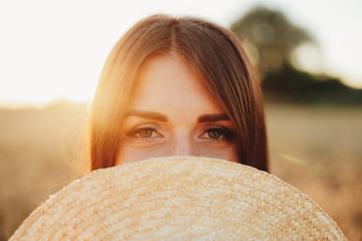 Girl in wheat field, girl's hand and wheat spikelet, sunset on field. High quality photo