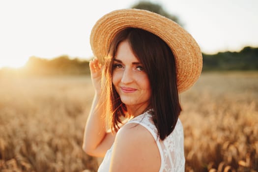 Girl in wheat field, girl's hand and wheat spikelet, sunset on field. High quality photo